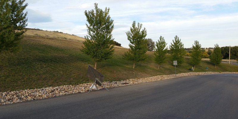 Photo of steep hillside mowing and Tall Grass Cutting at Osprey Subdivision Entrance